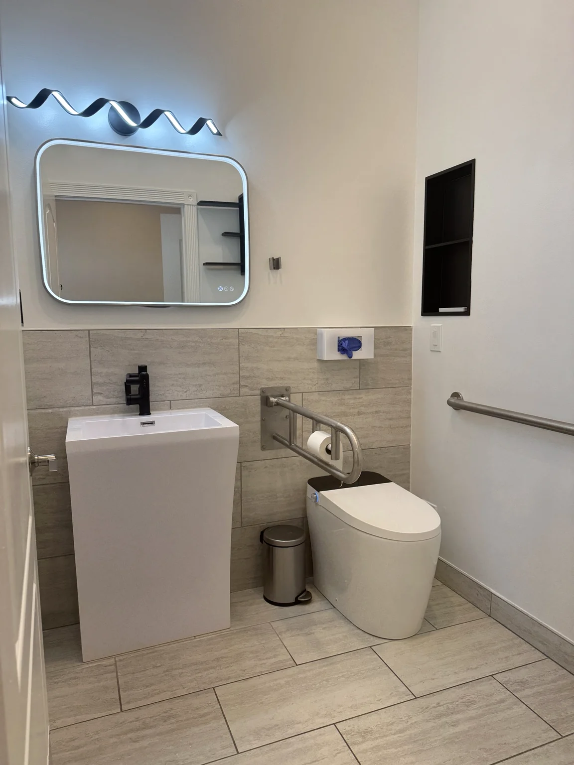Remodeled accessible bathroom with support bars at the Bothell home
